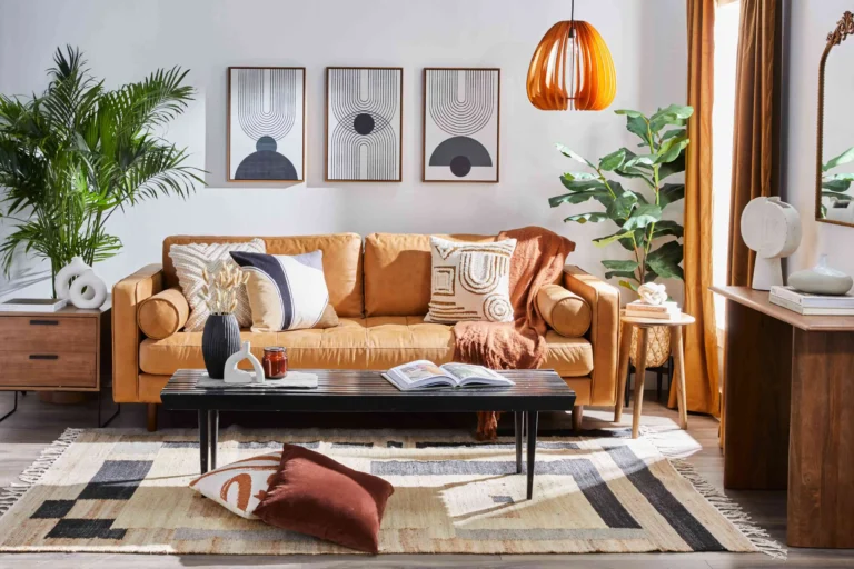 Budget home decor ideas under $50: large plants, oversized framed prints and a warm lamp that actually change how a living room reads from the doorway.
