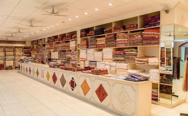 Colorful fabric rolls stacked at a wholesale cloth shop for home decor Bangalore curtains