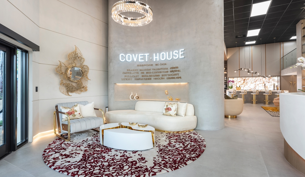 Covet House luxury furniture showroom with white curved sofa crystal chandelier and designer decor display