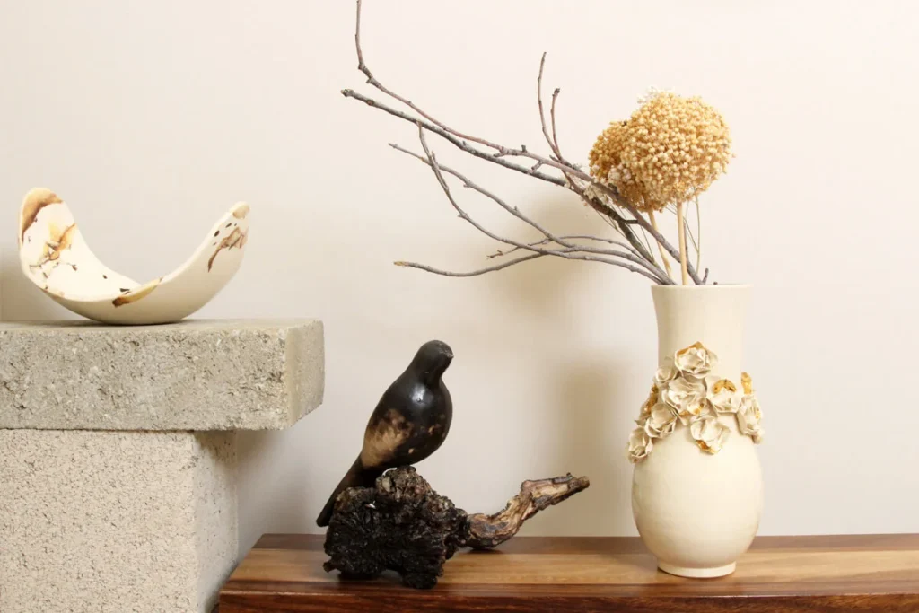 Budget handmade decor with ceramic vase and dried branches on wooden shelf