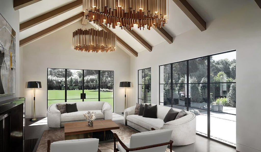 High end home decor Luxury living room flooded with natural light featuring exposed wooden ceiling beams and designer white sofas