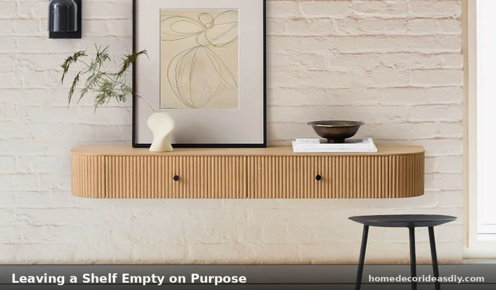 Floating shelves styling ideas  a nearly empty shelf with one small object showing how intentional negative space reads expensive