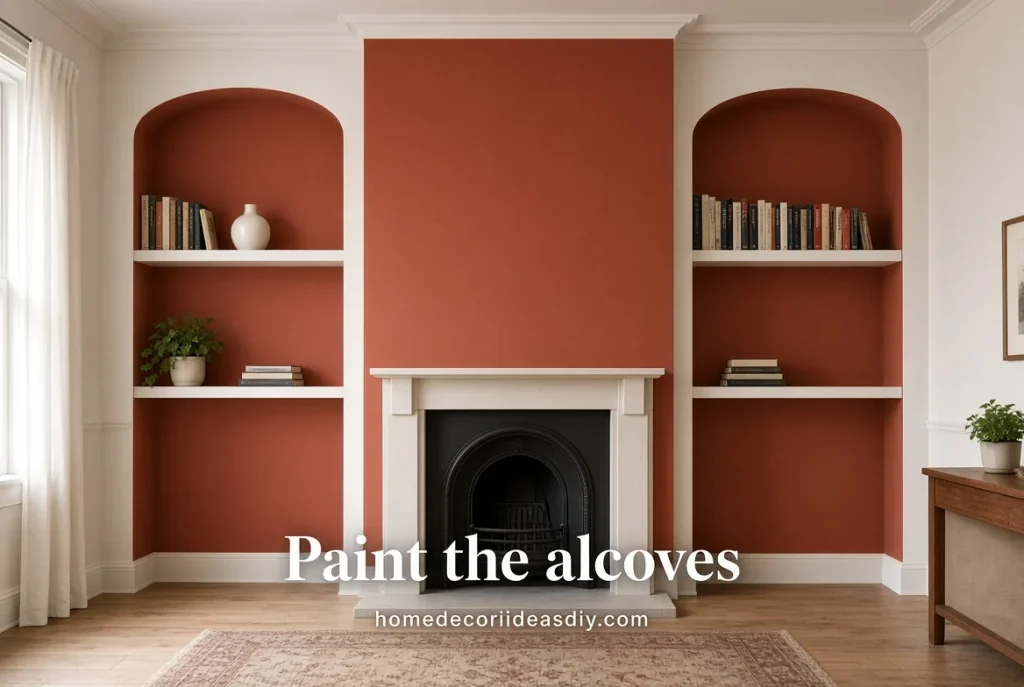 Rust-painted alcoves framing mixed shelves in a living room