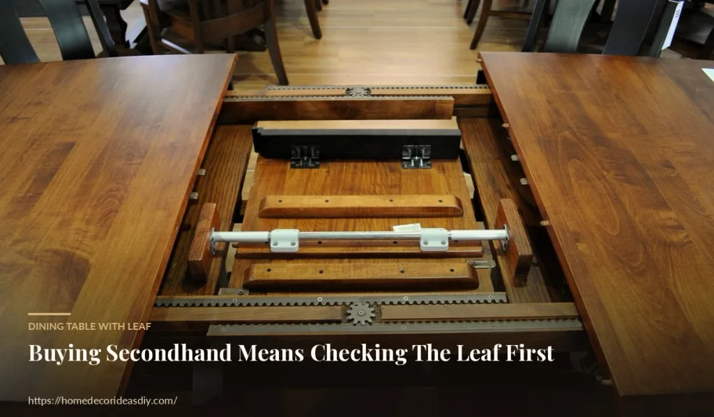 Dining table with leaf opened to show wooden slides gears and butterfly hardware.