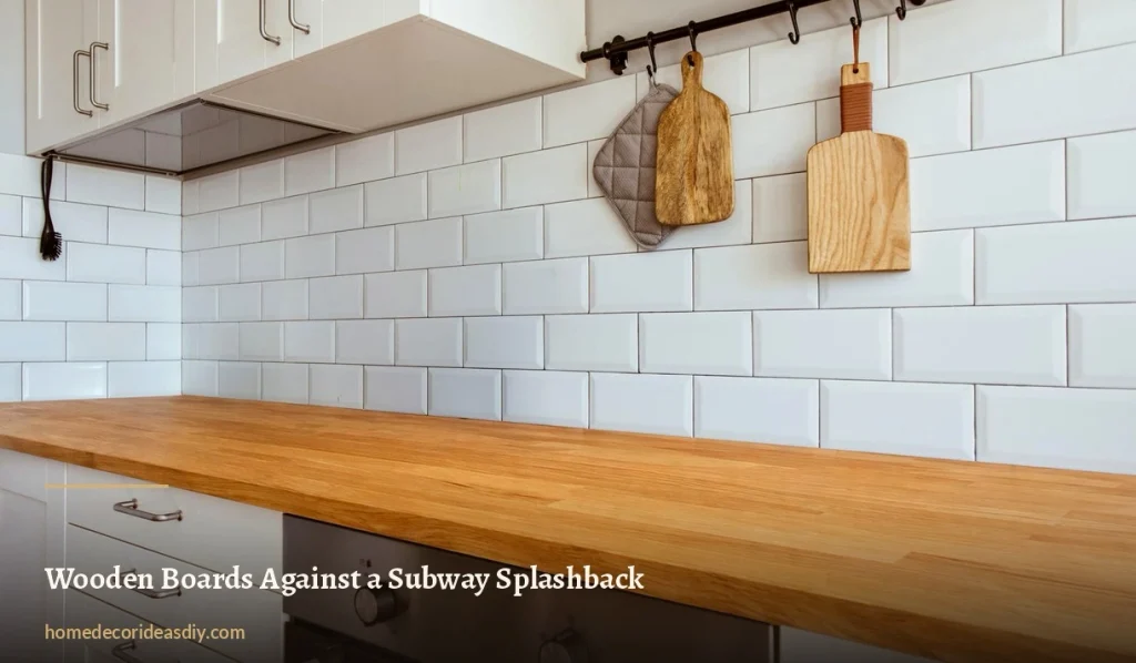 Wooden chopping boards hanging on a rail against white metro tiles above an oak worktop