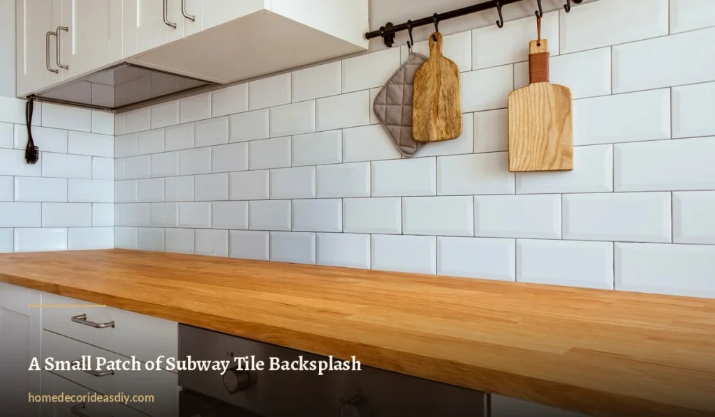White bevelled subway tile backsplash above a solid oak worktop in a white kitchen