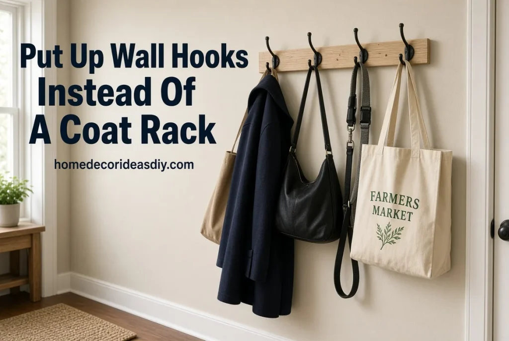 Wall hooks holding coats and bags instead of a floor coat rack – budget small home organization ideas.
